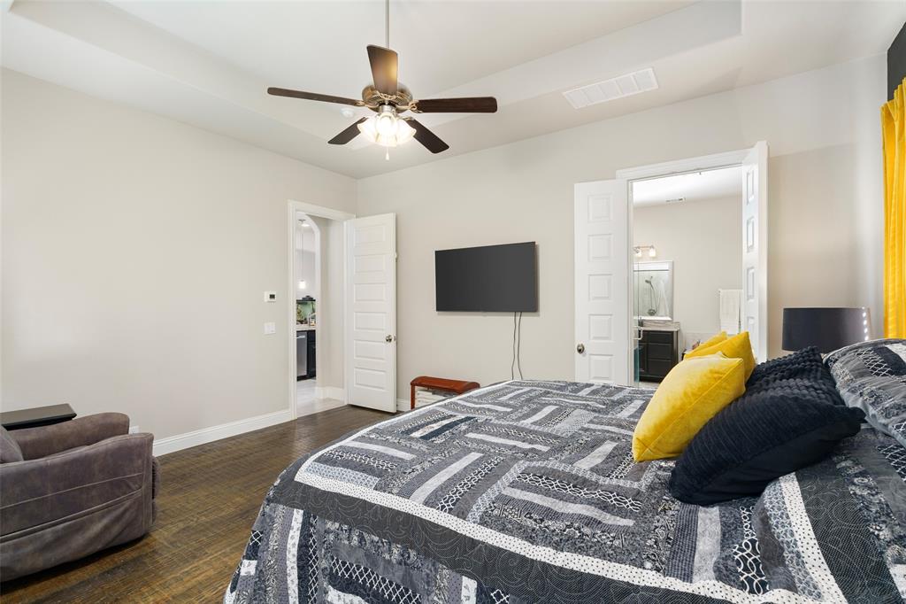 191 Daniel Drive Van Alstyne, TX 75495 - Photo 11 of 30 a bedroom with a bed and a flat screen tv
