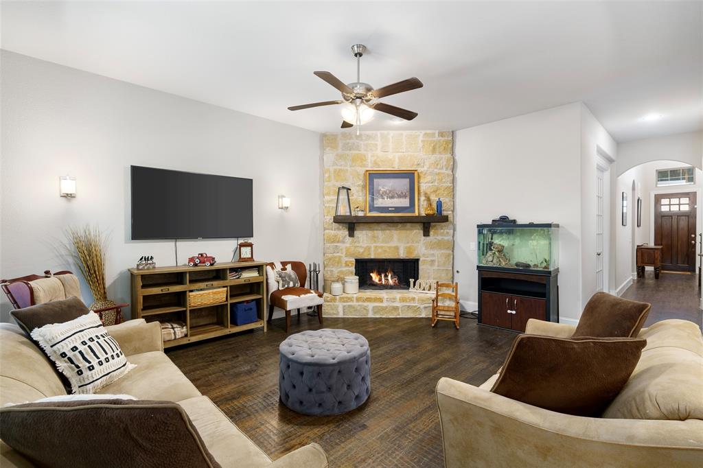 191 Daniel Drive Van Alstyne, TX 75495 - Photo 18 of 30 a living room with furniture a flat screen tv and a fireplace