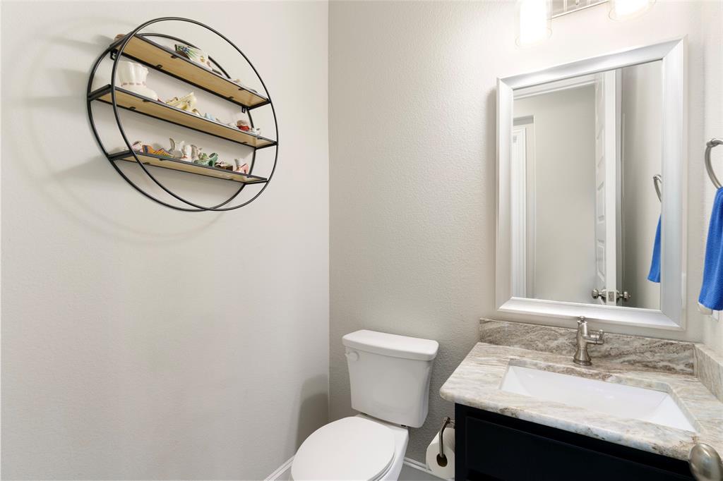 191 Daniel Drive Van Alstyne, TX 75495 - Photo 9 of 30 a bathroom with a sink a toilet and a mirror