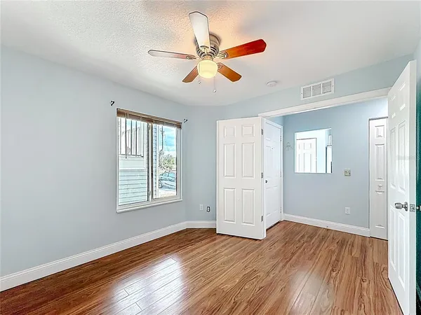 a view of an empty room with wooden floor