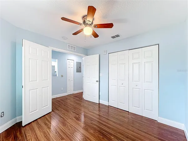 a view of an empty room with wooden floor