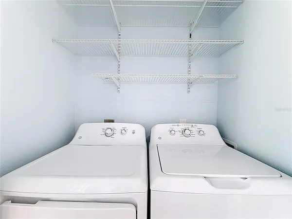 a view of storage and utility room with washer and dryer