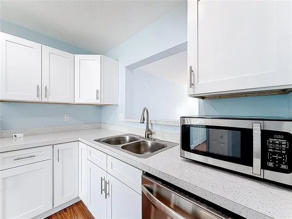 a kitchen with a sink and cabinets