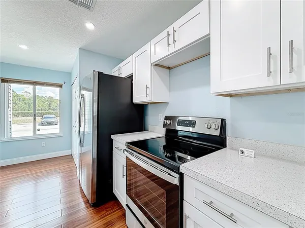 a kitchen with appliances cabinets and a sink