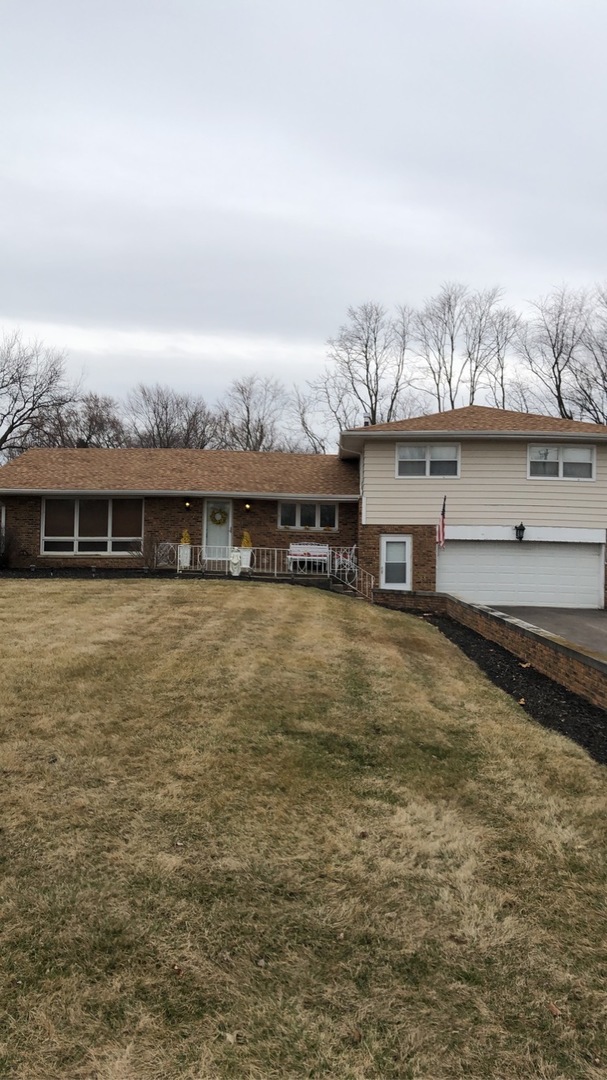 1940 Jericho Road Aurora, IL 60506 - Photo 1 of 29 a front view of a house with a yard