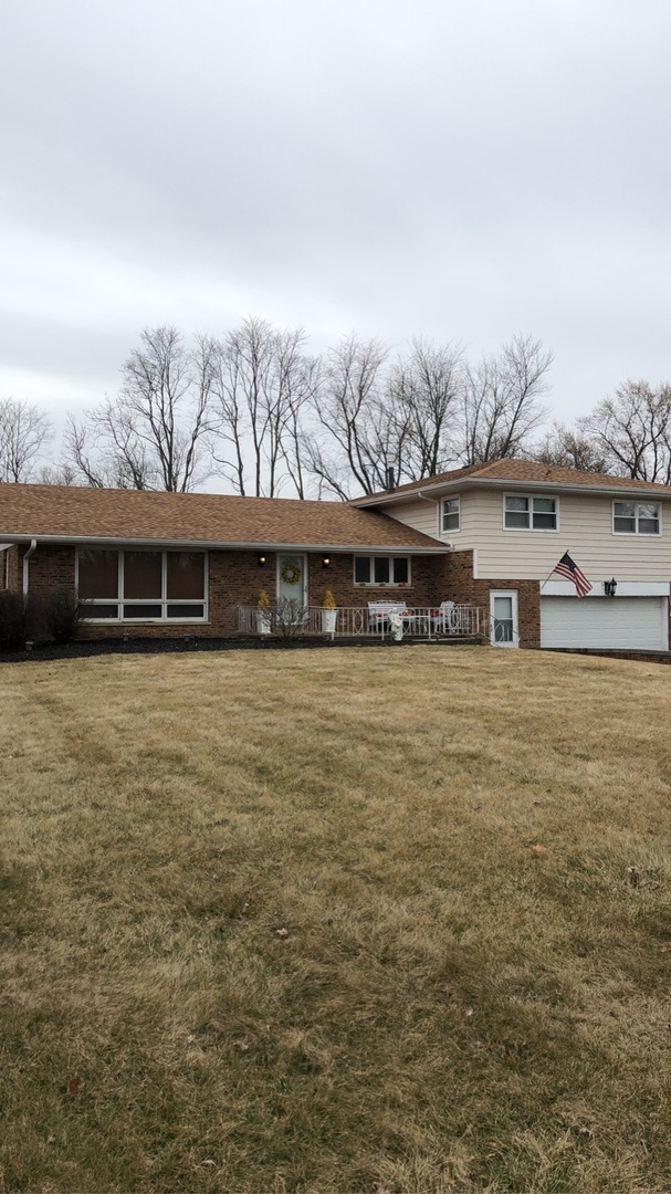 1940 Jericho Road Aurora, IL 60506 - Photo 3 of 29 a front view of a house with a yard