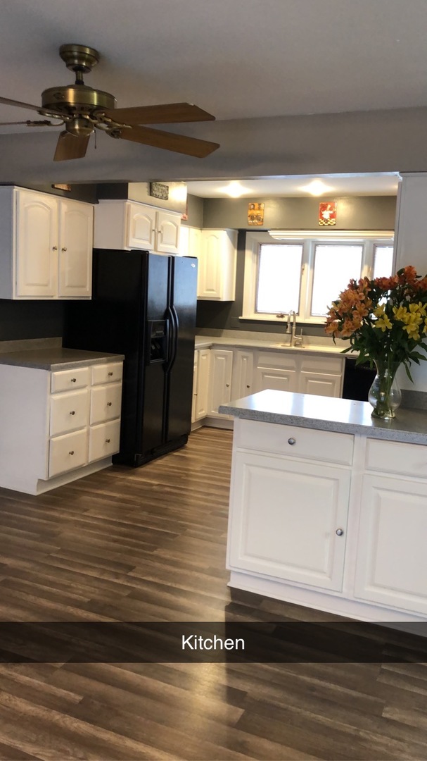 1940 Jericho Road Aurora, IL 60506 - Photo 8 of 29 a view of living room kitchen with stainless steel appliances wooden floor and chandelier