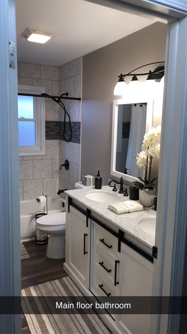 1940 Jericho Road Aurora, IL 60506 - Photo 9 of 29 a bathroom with a granite countertop sink a toilet and a mirror