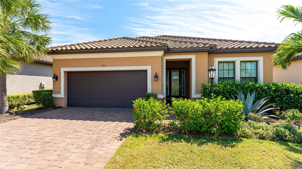 4511 Terrazza Court Lakewood Ranch, FL 34211 - Photo 1 of 65 a front view of a house with a yard