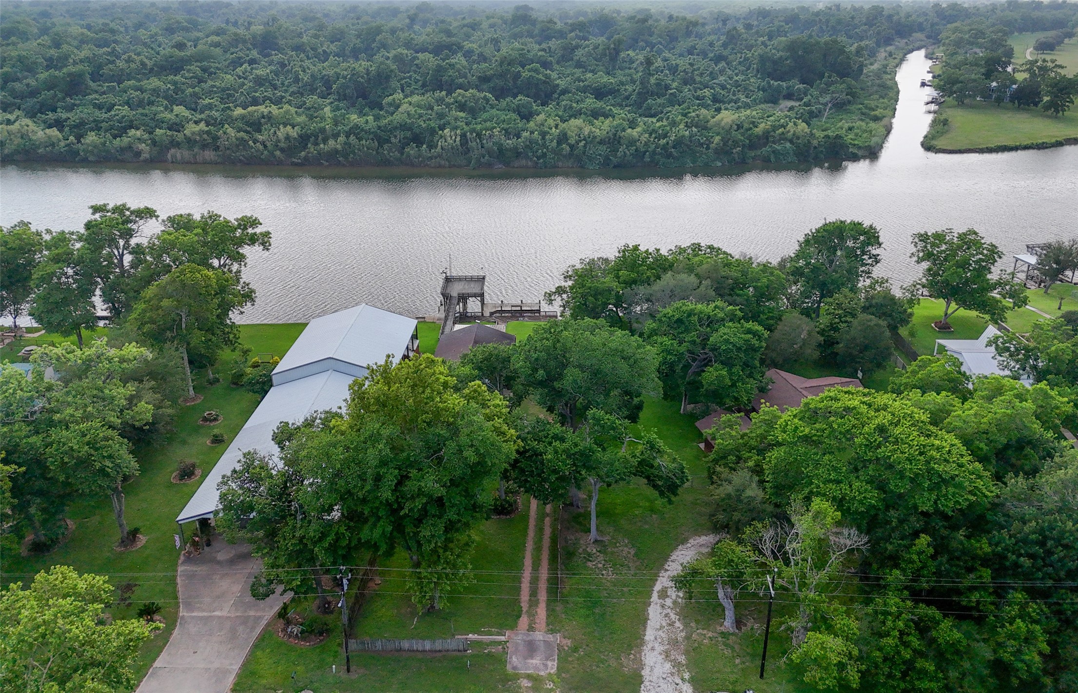 215 Selkirk Road Bay City, TX 77414 - Photo 22 of 36 an aerial view of a house with a yard and lake view