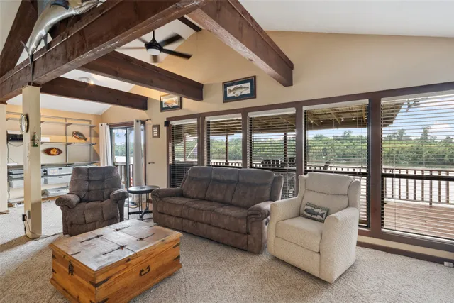 a dining room with furniture and large window