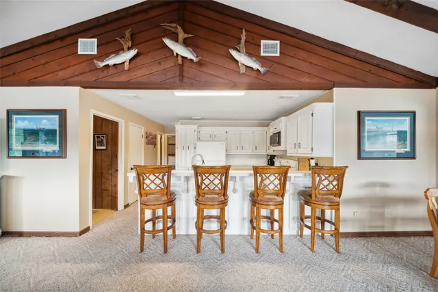a view of an entryway with furniture and a kitchen