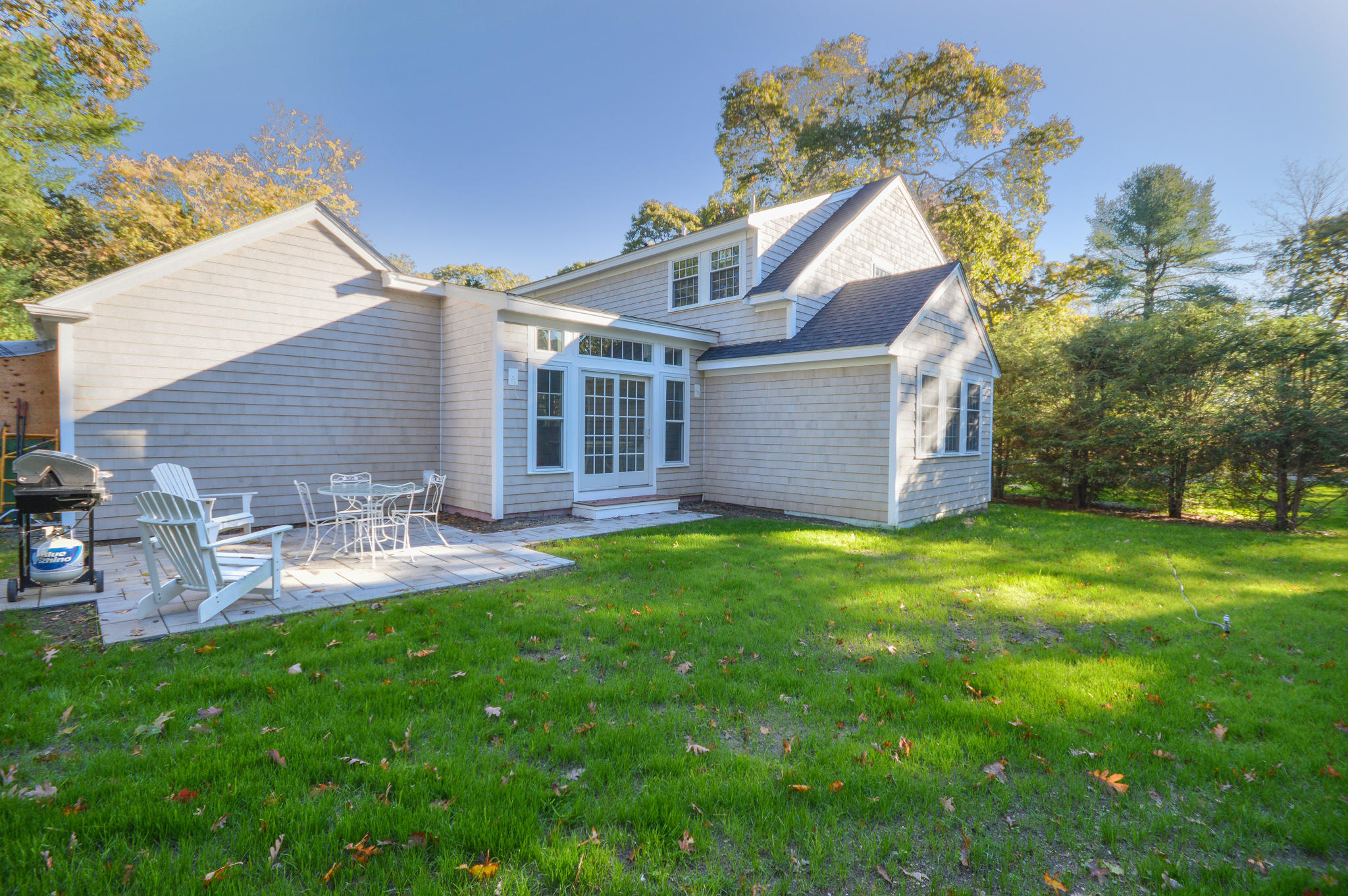 140 Scraggy Neck Road Cataumet, MA 02534 - Photo 25 of 39 a view of a house with a yard and sitting area