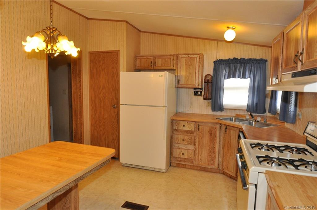 3088 Armenia Road Chester, SC 29706 - Photo 6 of 19 a kitchen with stainless steel appliances granite countertop a refrigerator a stove and a sink