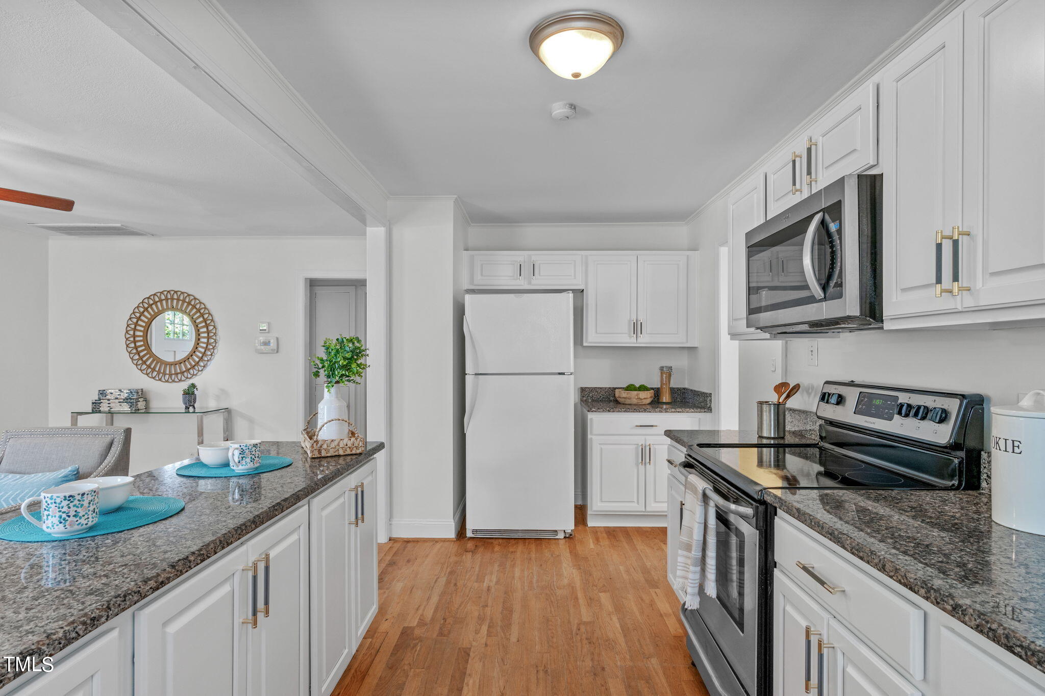 816 Colleton Road Raleigh, NC 27610 - Photo 18 of 49 a kitchen with granite countertop stainless steel appliances a stove top oven a sink a counter space and cabinets