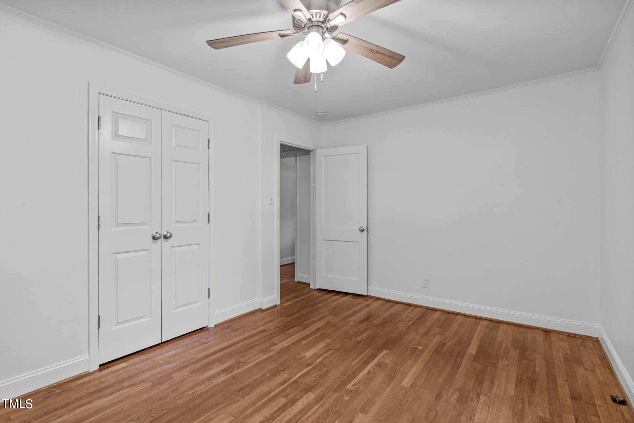 816 Colleton Road Raleigh, NC 27610 - Photo 29 of 49 a view of an empty room with wooden floor