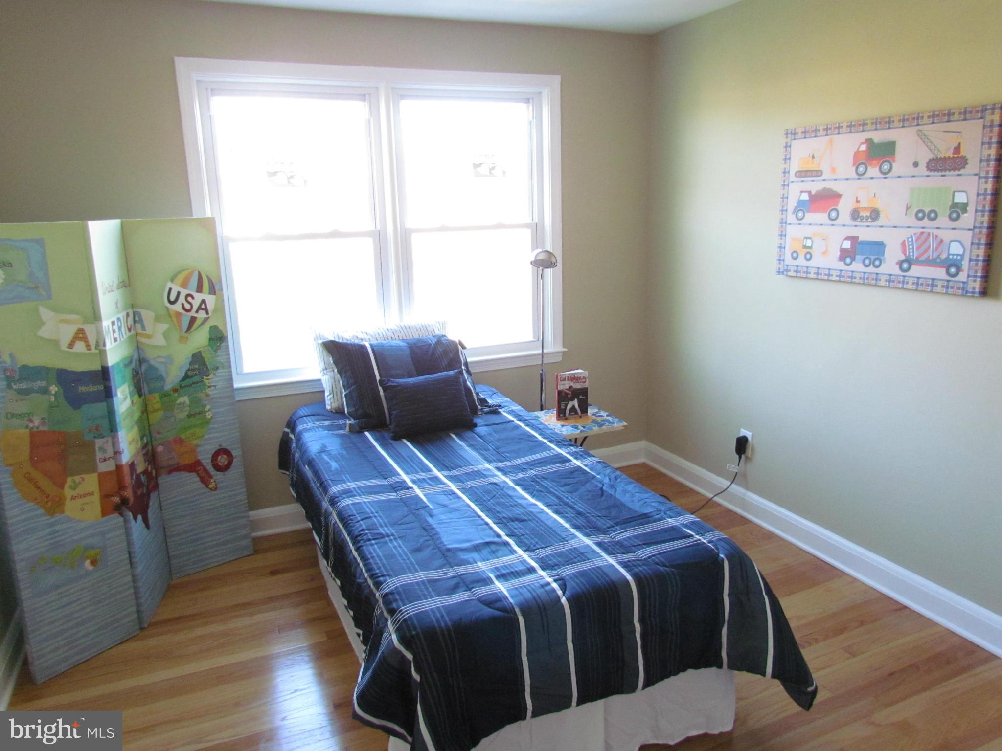 1634 Ingram Road Baltimore, MD 21239 - Photo 11 of 21 a bedroom with a bed and wooden floor