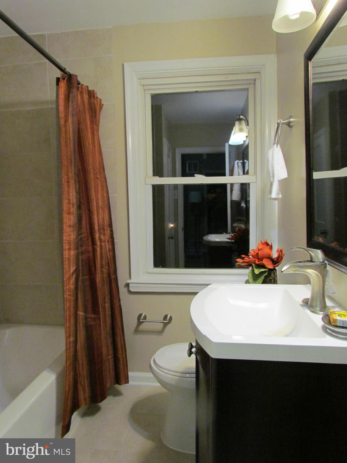 1634 Ingram Road Baltimore, MD 21239 - Photo 13 of 21 a bathroom with a sink a toilet and a bathtub