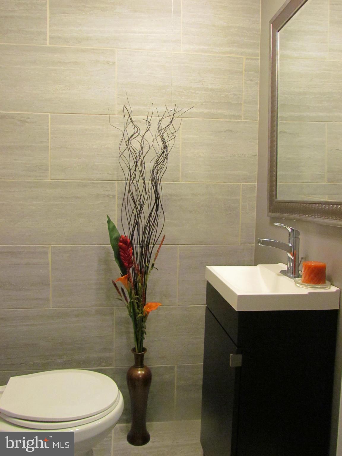 1634 Ingram Road Baltimore, MD 21239 - Photo 19 of 21 a bathroom with a sink a toilet and a mirror