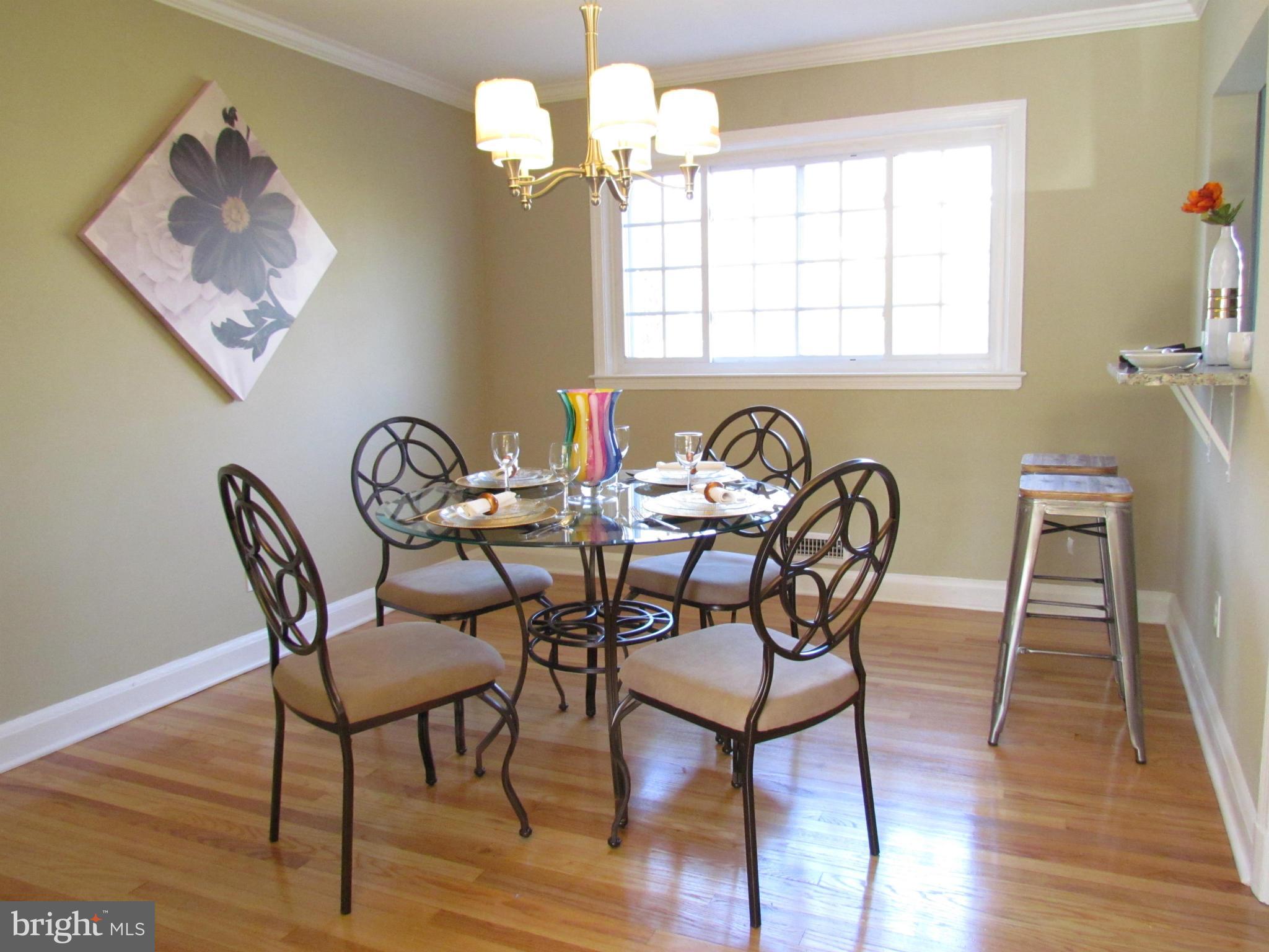 1634 Ingram Road Baltimore, MD 21239 - Photo 6 of 21 a dining room with furniture a chandelier and wooden floor