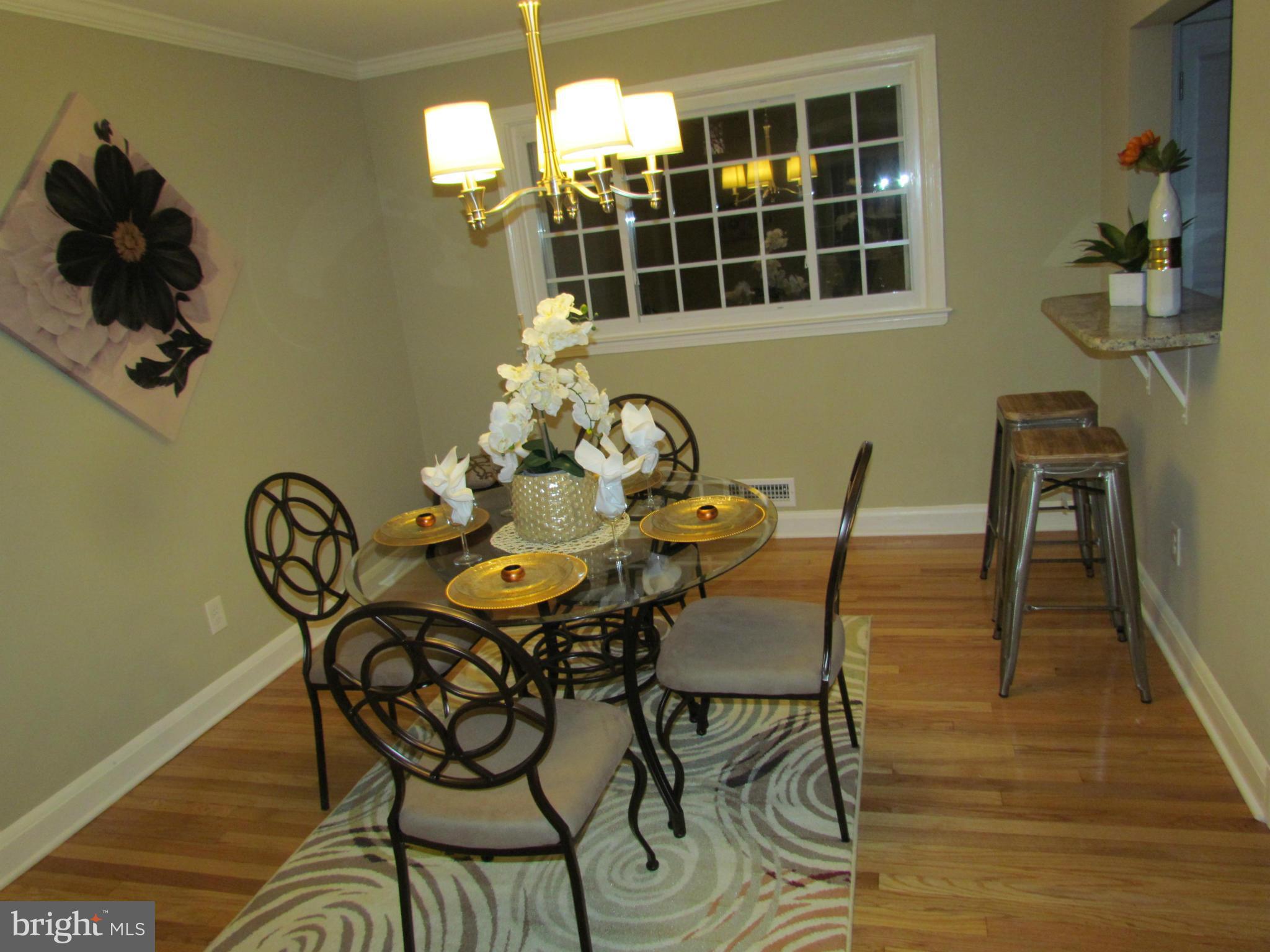1634 Ingram Road Baltimore, MD 21239 - Photo 7 of 21 a view of a dining room with furniture window and wooden floor