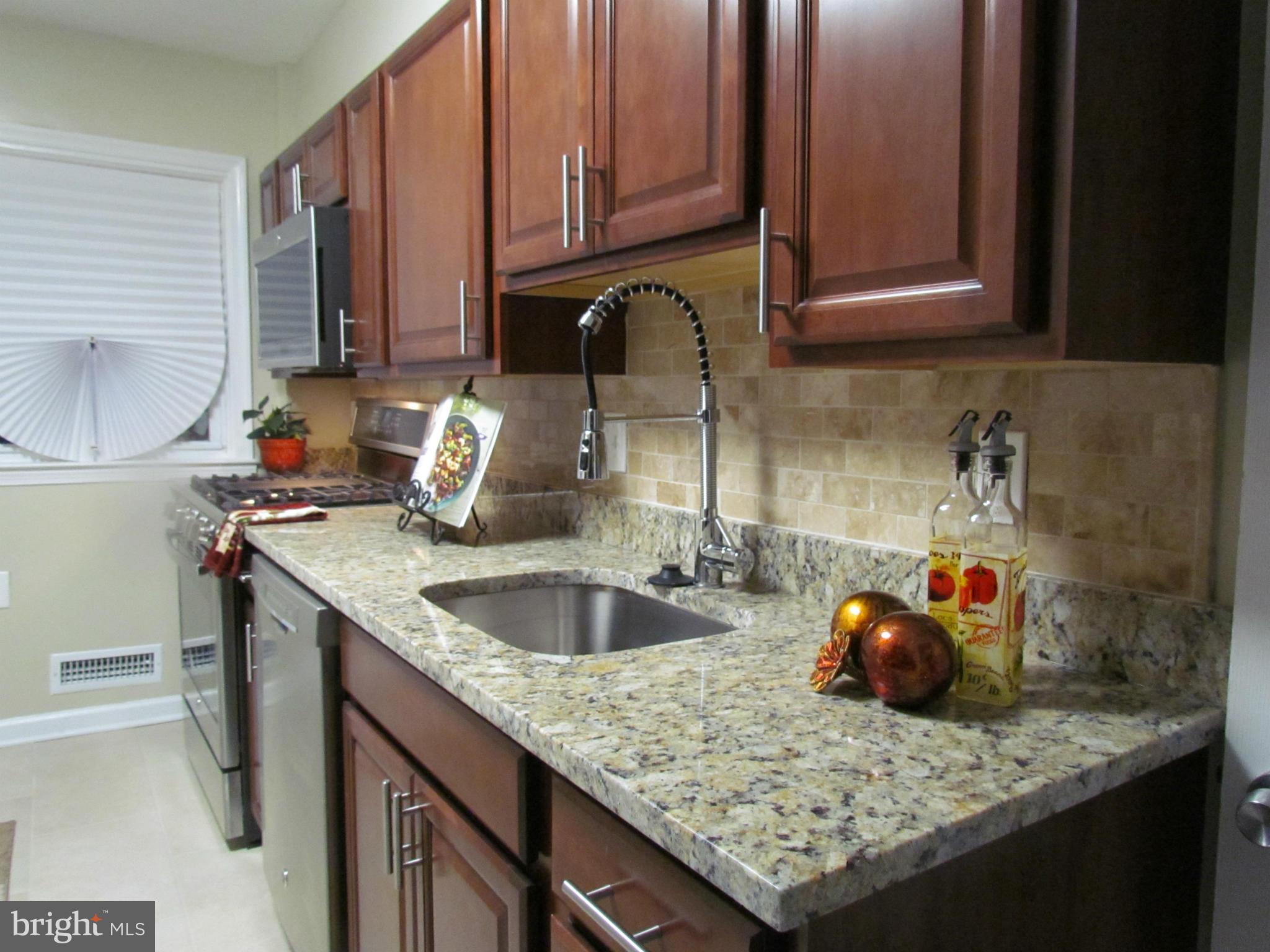 1634 Ingram Road Baltimore, MD 21239 - Photo 8 of 21 a kitchen with granite countertop a sink stove and cabinets