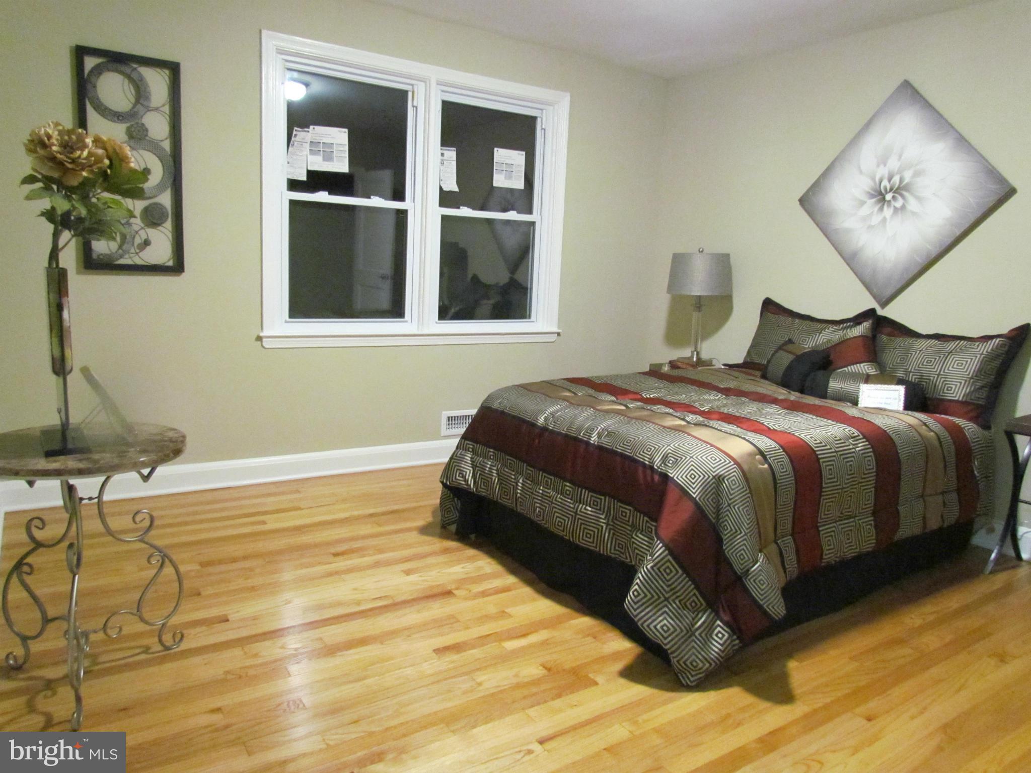 1634 Ingram Road Baltimore, MD 21239 - Photo 10 of 21 a bedroom with a bed and painting on the wall