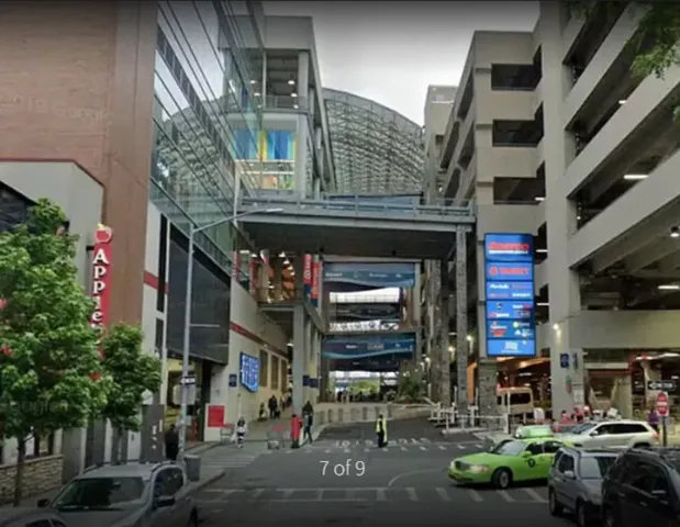 a view of a cars park in front of a building