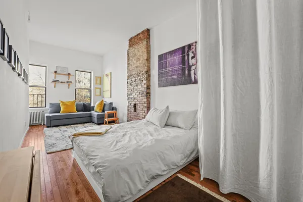 a living room with furniture and a painting on the wall