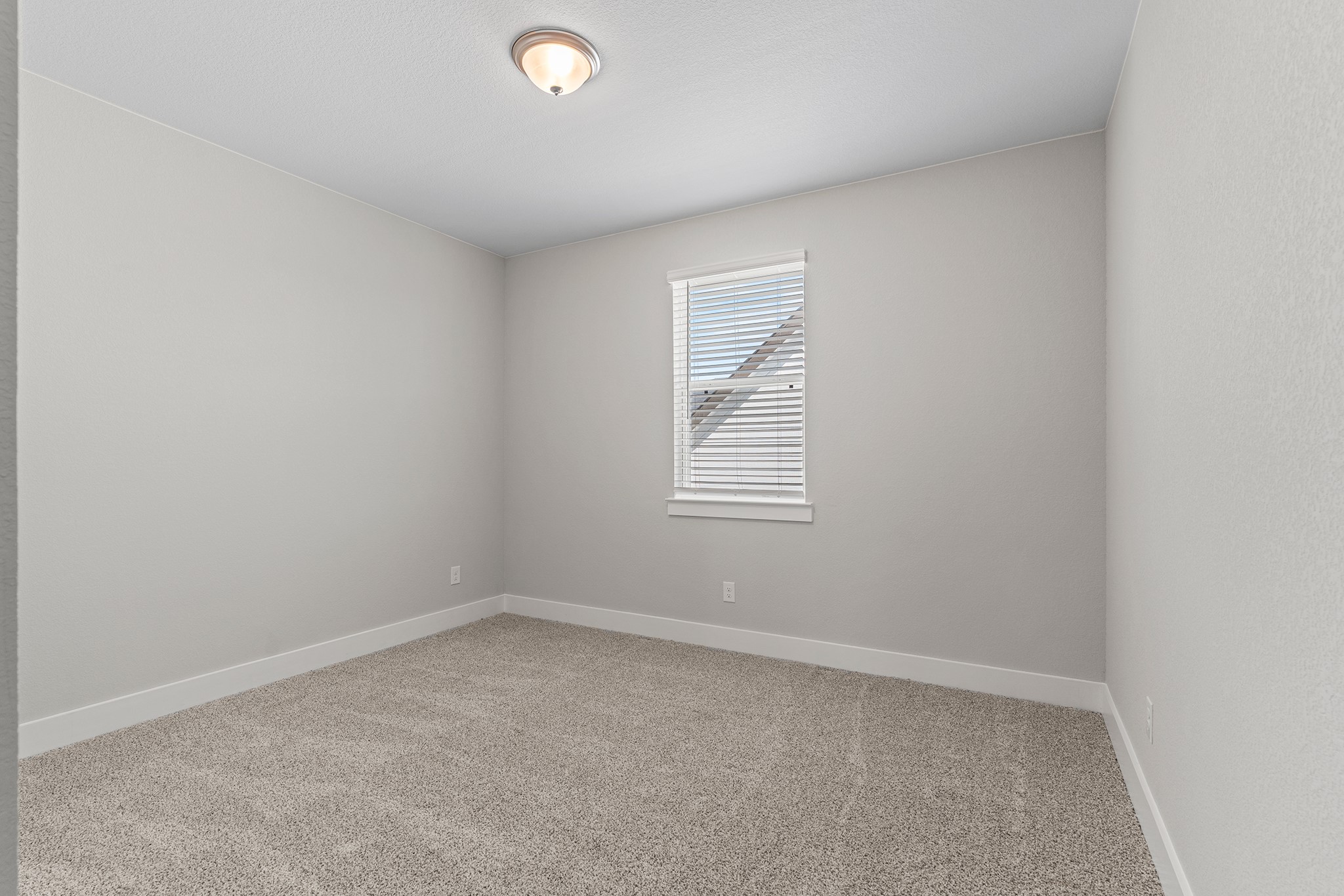 2112 Tobiano Trace Georgetown, TX 78633 - Photo 32 of 40 Spare room featuring light colored carpet and baseboards