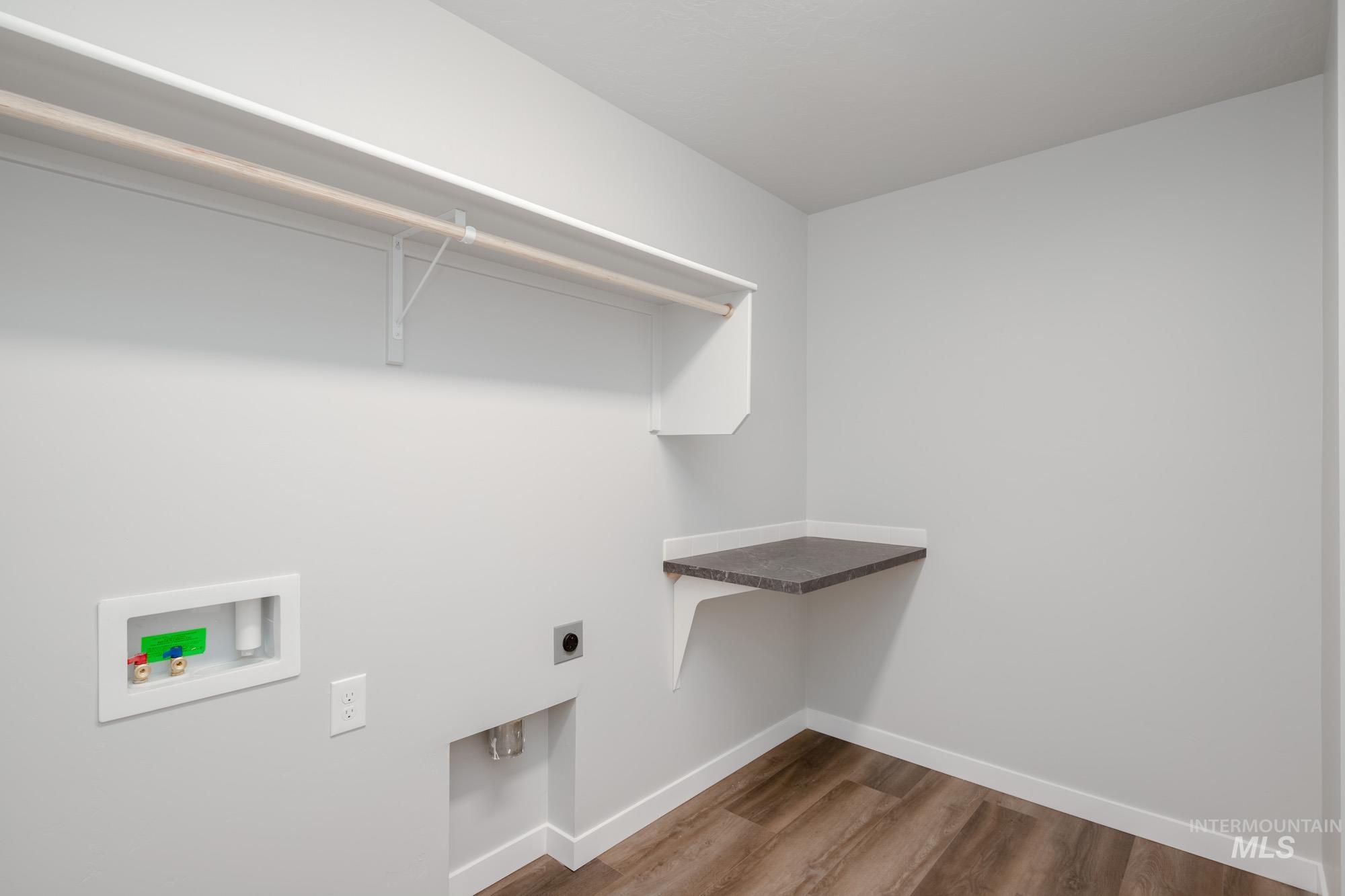 2940 North Schimigadoon Way Eagle, ID 83616 - Photo 17 of 21 Washroom featuring dark wood finished floors, electric dryer hookup, and washer hookup