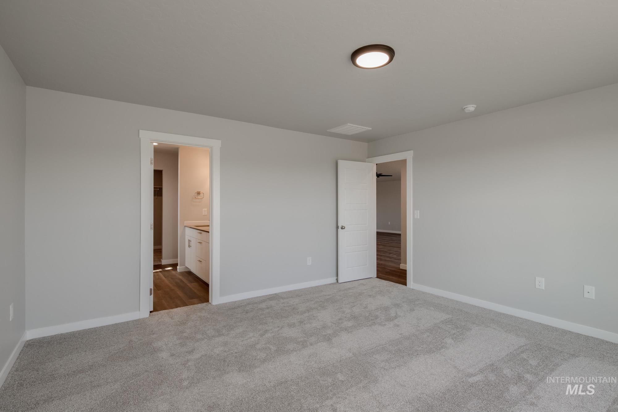 2940 North Schimigadoon Way Eagle, ID 83616 - Photo 19 of 21 Unfurnished bedroom with carpet and connected bathroom