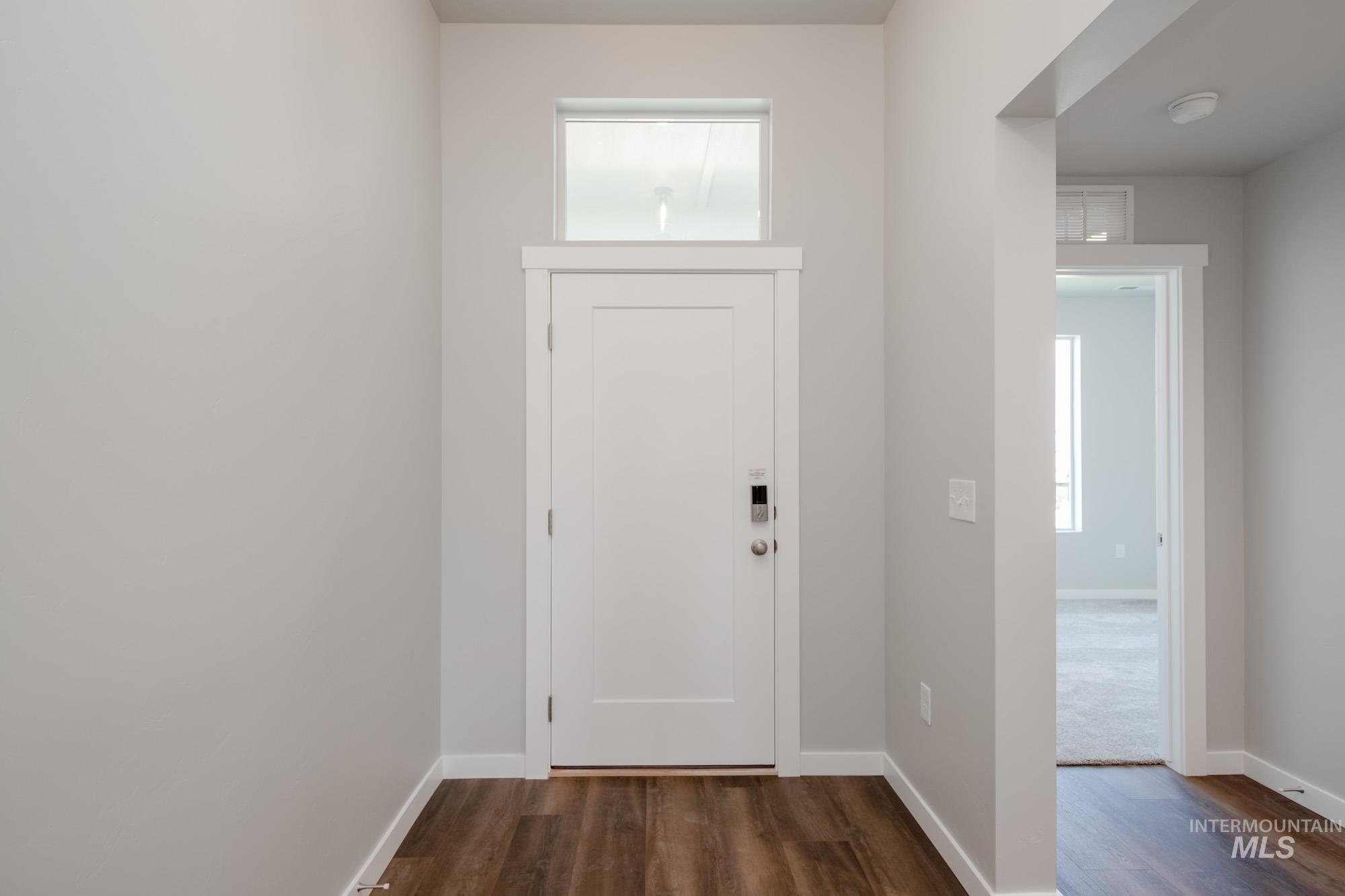 2940 North Schimigadoon Way Eagle, ID 83616 - Photo 2 of 21 Entrance foyer with healthy amount of natural light and dark wood finished floors