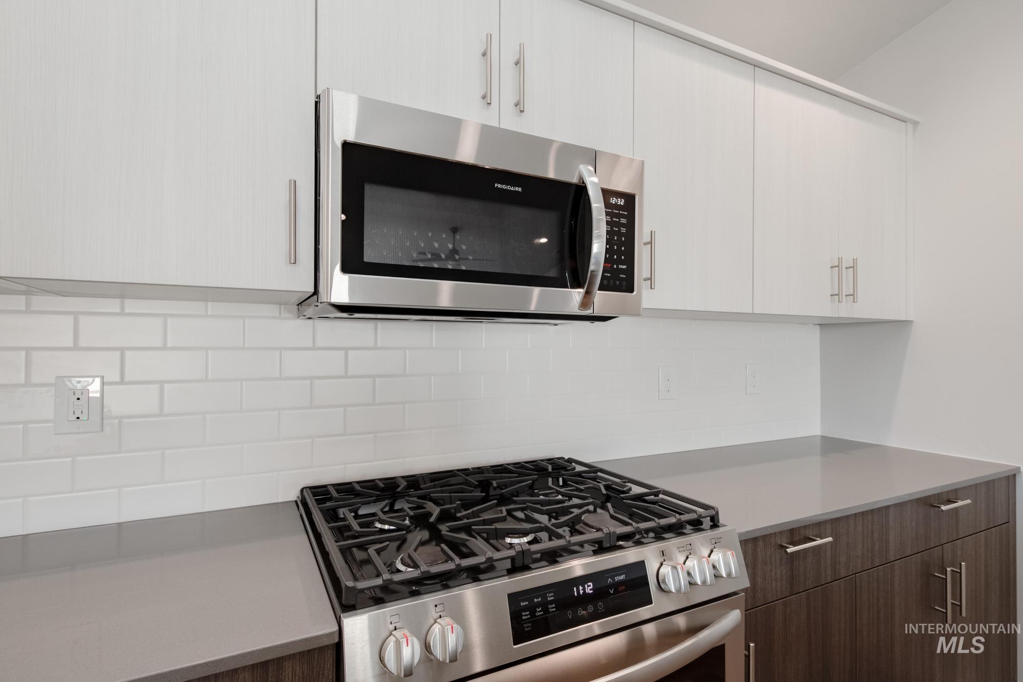 2940 North Schimigadoon Way Eagle, ID 83616 - Photo 5 of 21 Kitchen featuring stainless steel appliances, modern cabinets, and backsplash