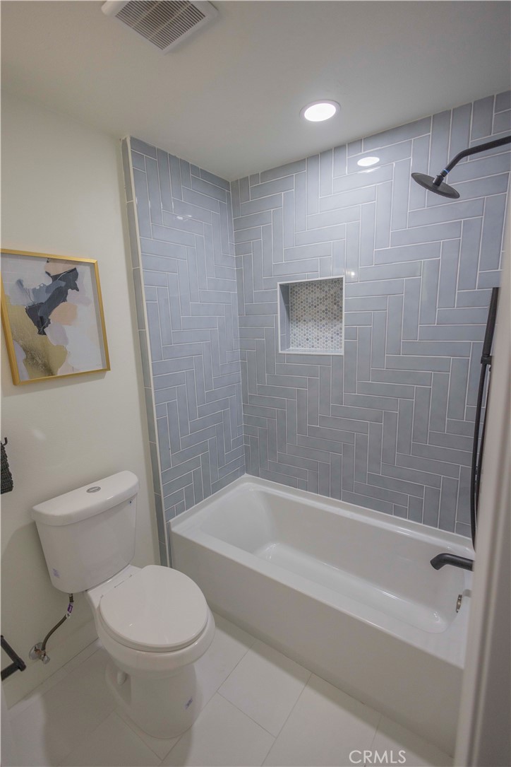 20530 Clark Street Perris, CA 92570 - Photo 11 of 25 a bathroom with a toilet and a bathtub