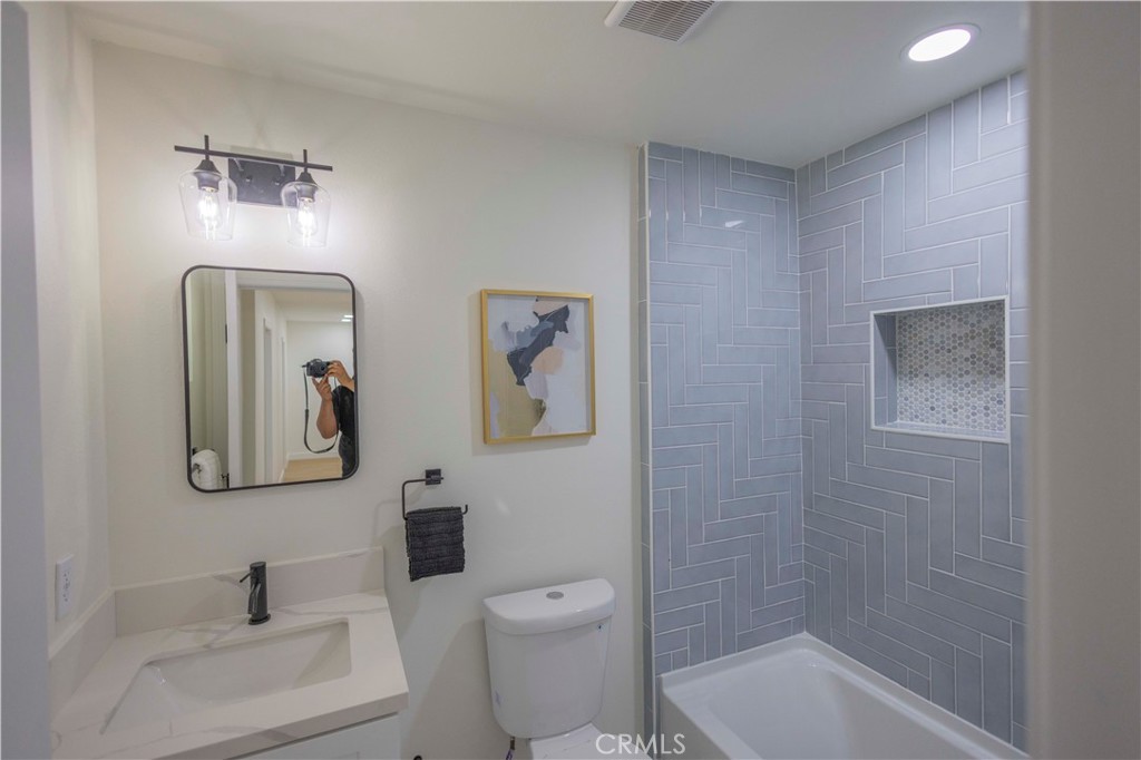 20530 Clark Street Perris, CA 92570 - Photo 12 of 25 a bathroom with a toilet a sink and mirror