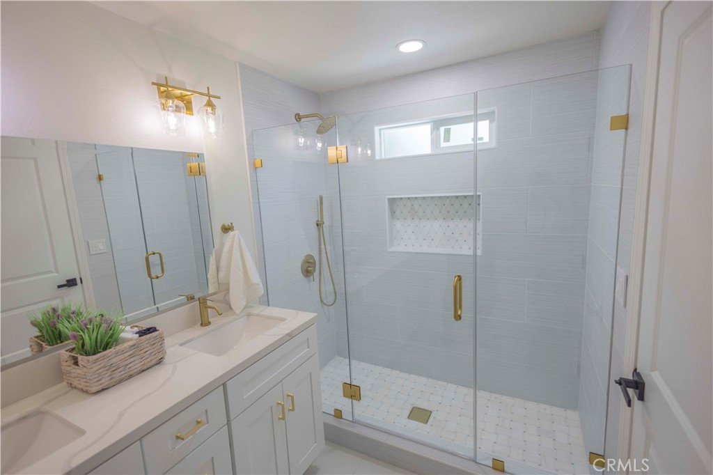 20530 Clark Street Perris, CA 92570 - Photo 13 of 25 a bathroom with a shower sink and mirror