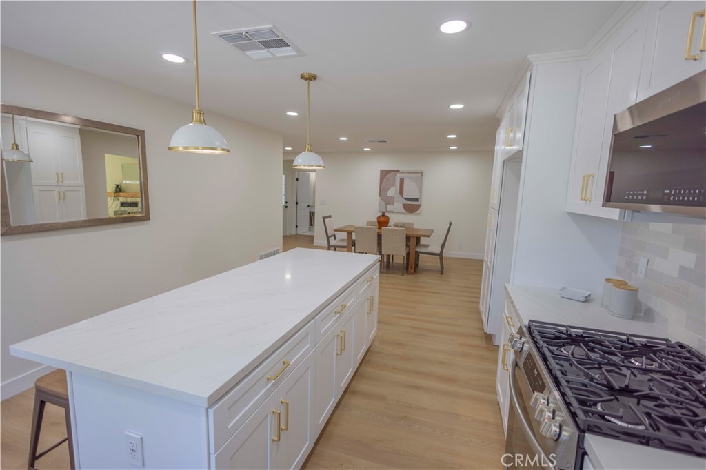 20530 Clark Street Perris, CA 92570 - Photo 9 of 25 a large white kitchen with a sink a stove and a refrigerator