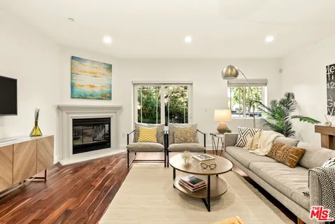 a living room with furniture a rug and a fireplace