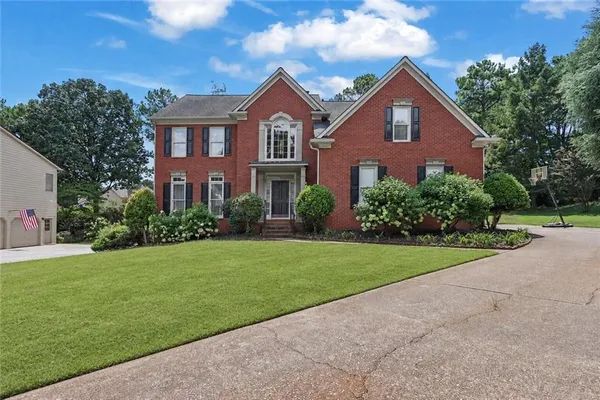 a front view of a house with a yard