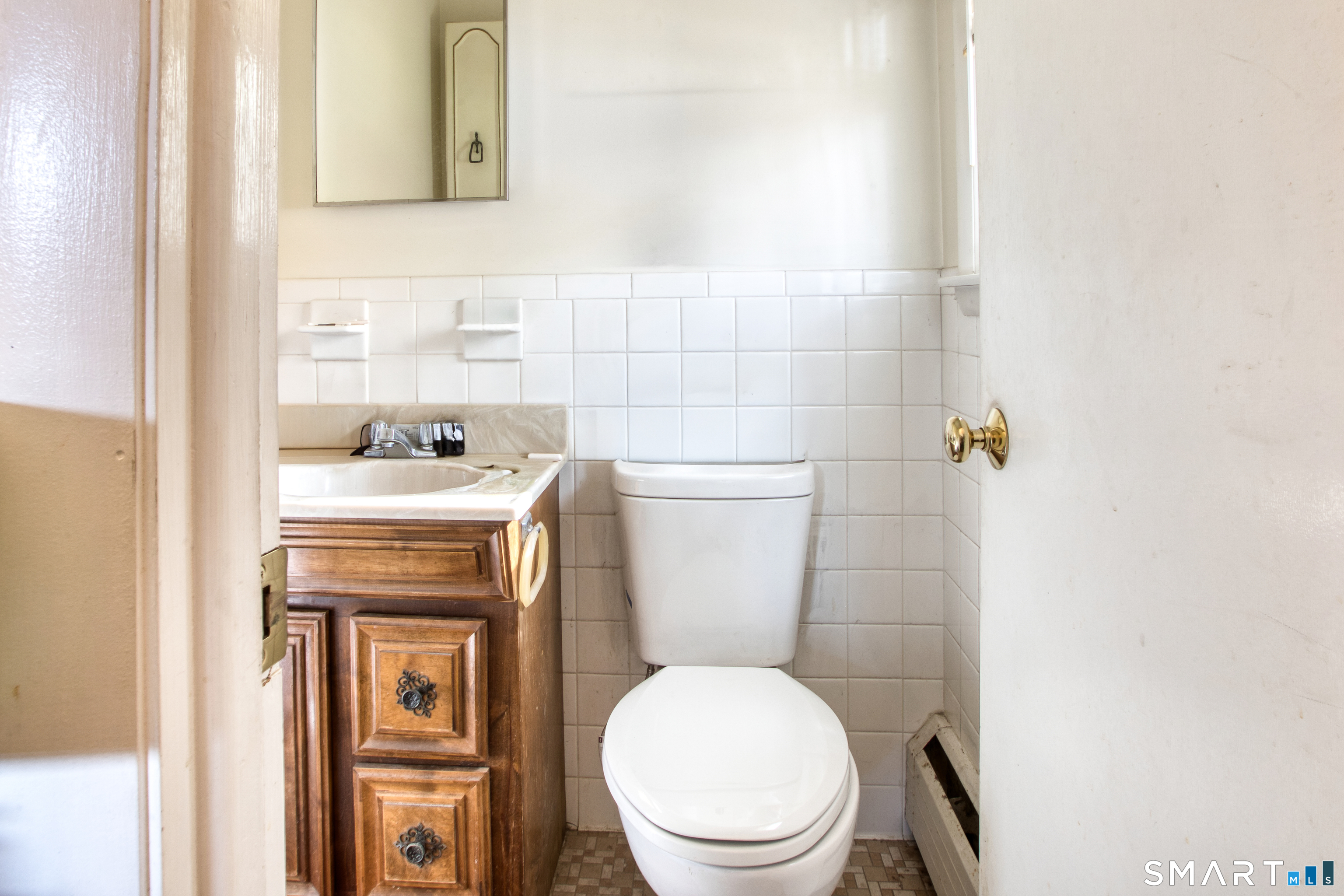 123 Andover Road East Hartford, CT 06108 - Photo 12 of 22 a white toilet sitting next to a bathroom sink