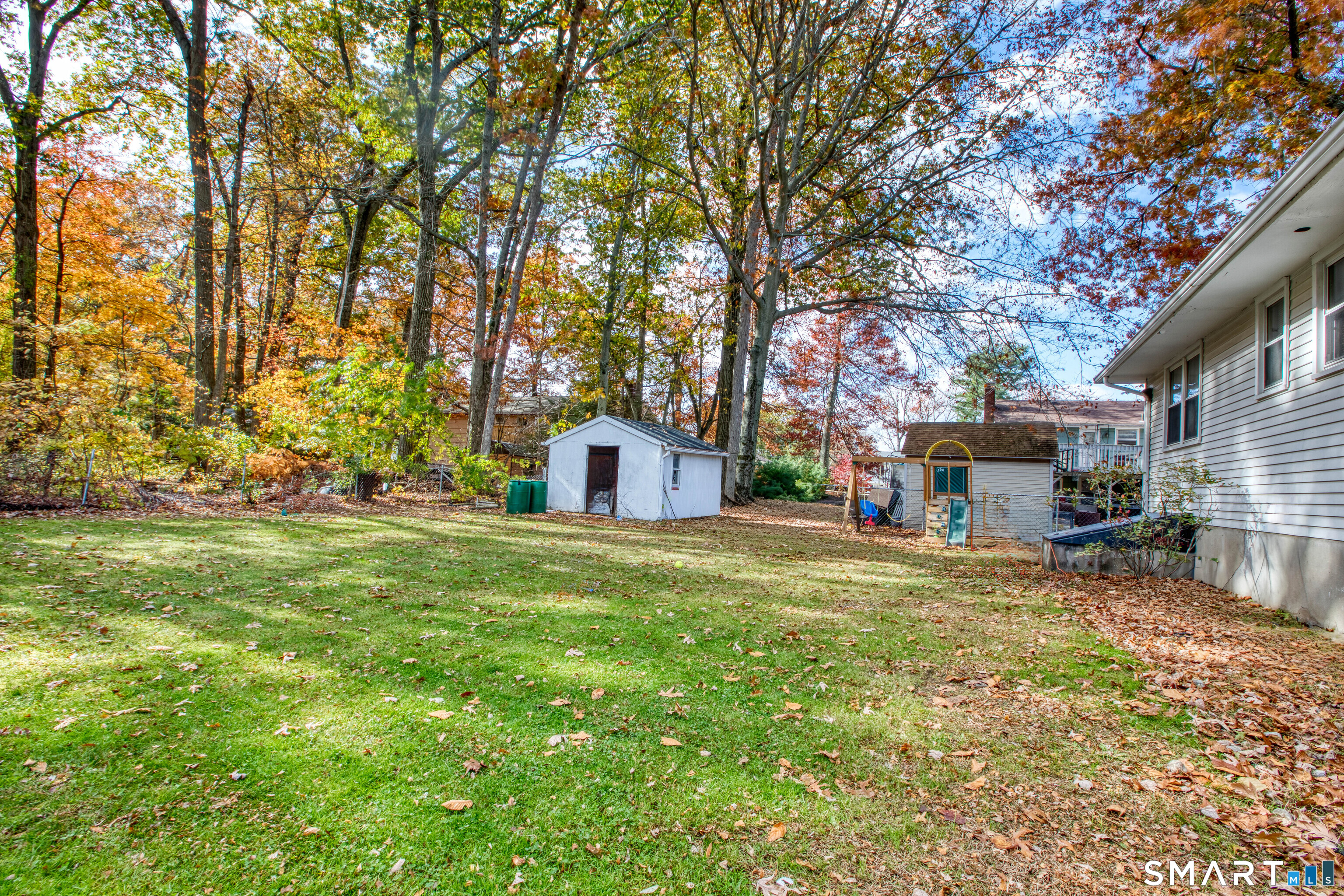 123 Andover Road East Hartford, CT 06108 - Photo 18 of 22 a yellow house in middle of the forest