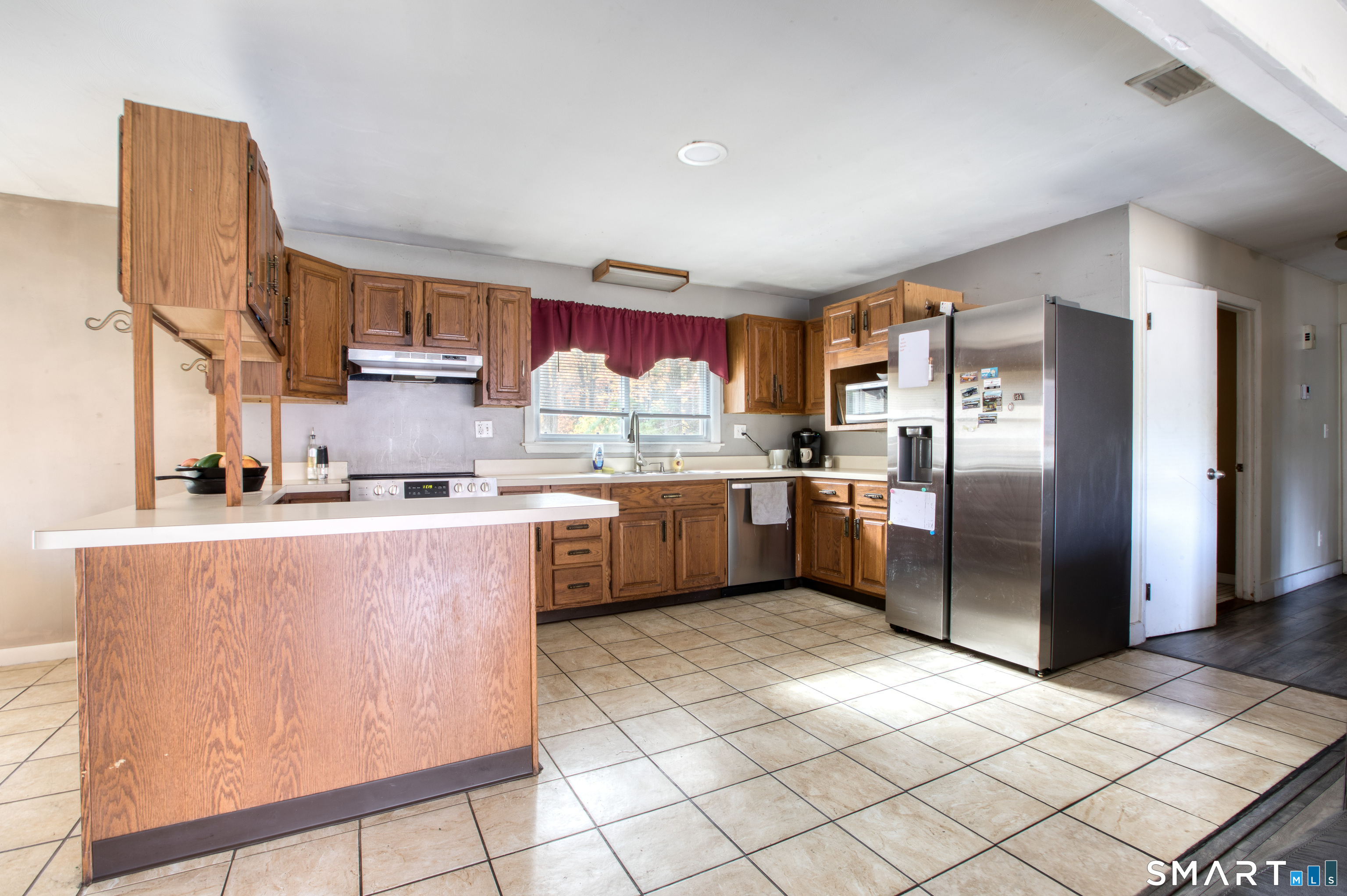 123 Andover Road East Hartford, CT 06108 - Photo 4 of 22 a kitchen with stainless steel appliances granite countertop a refrigerator a stove a sink and a microwave