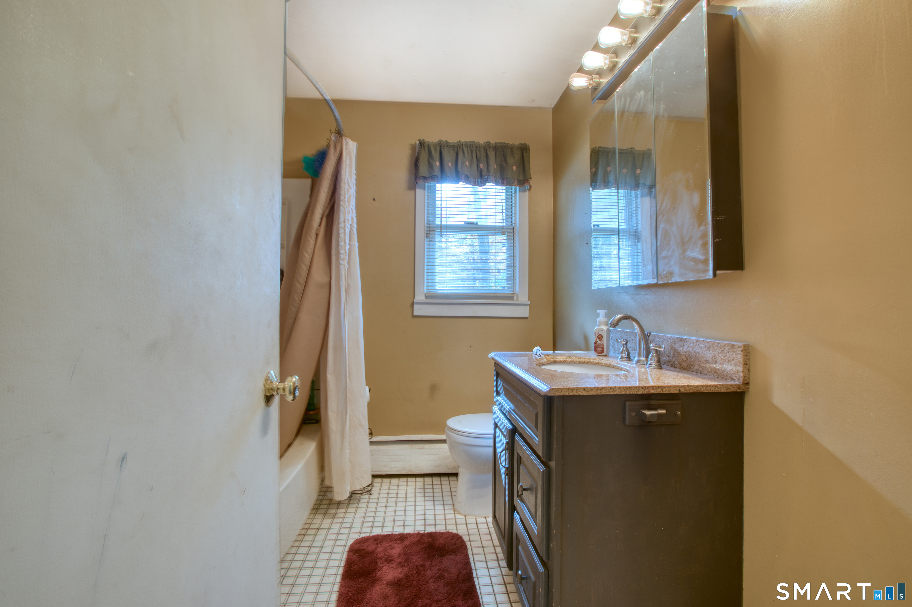 123 Andover Road East Hartford, CT 06108 - Photo 10 of 22 a bathroom with a sink a toilet and mirror