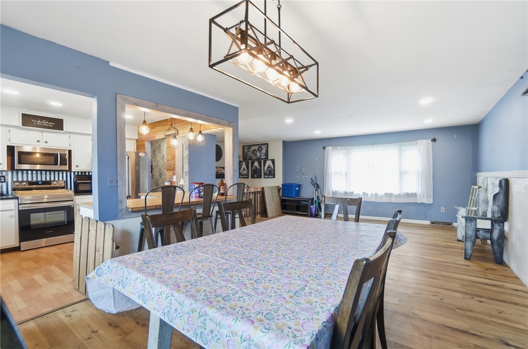 290 Ginghamsburg Road Tipp City, OH 45371 - Photo 12 of 49 This inviting space combines a functional kitchen with an open dining area, perfect for daily living.