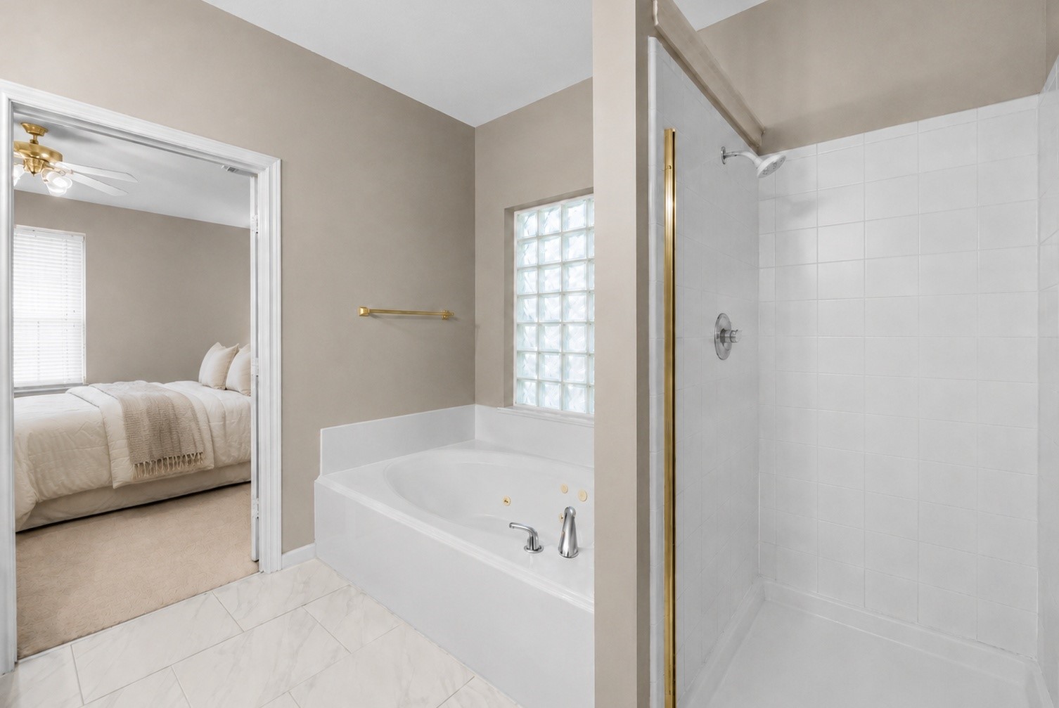 5724 Shady Hollow Court Rosharon, TX 77583 - Photo 13 of 27 Primary suite bathroom featuring a relaxing Jacuzzi tub, separate stand-up shower, and a bright, neutral design. This spacious en-suite also includes a generous closet not pictured, offering excellent storage and everyday functionality.