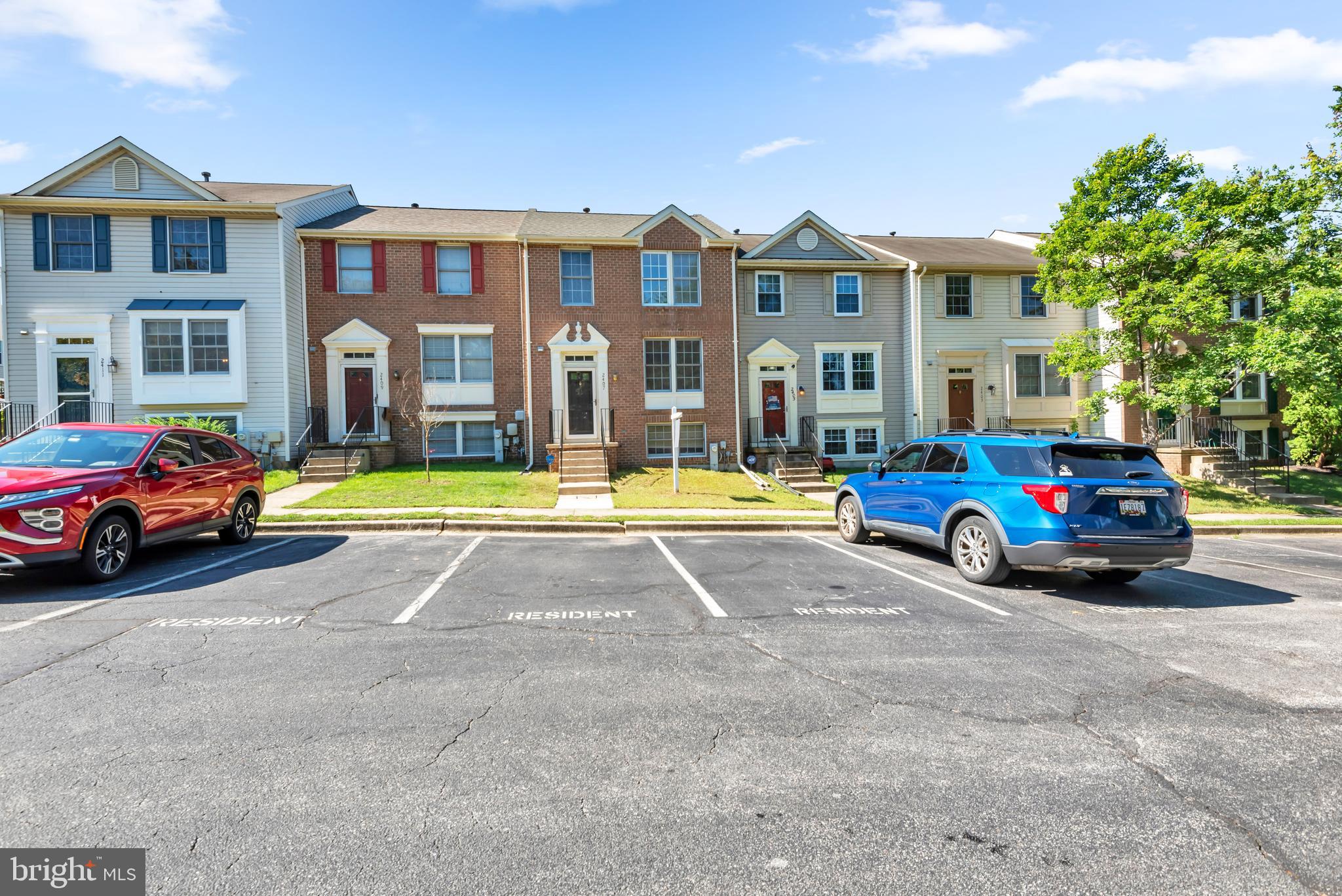 a view of building with cars parked in front of it