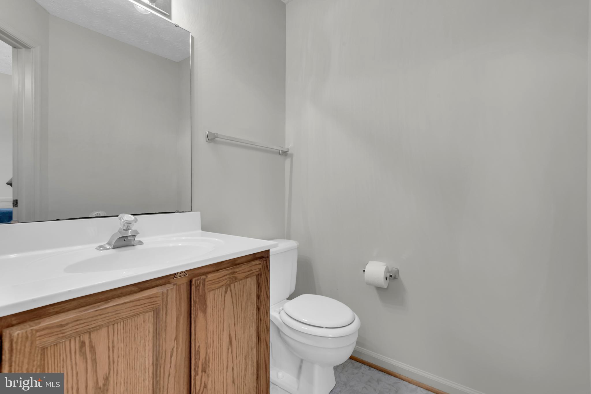 2407 Warm Spring Way Odenton, MD 21113 - Photo 14 of 45 a bathroom with a sink a toilet and mirror
