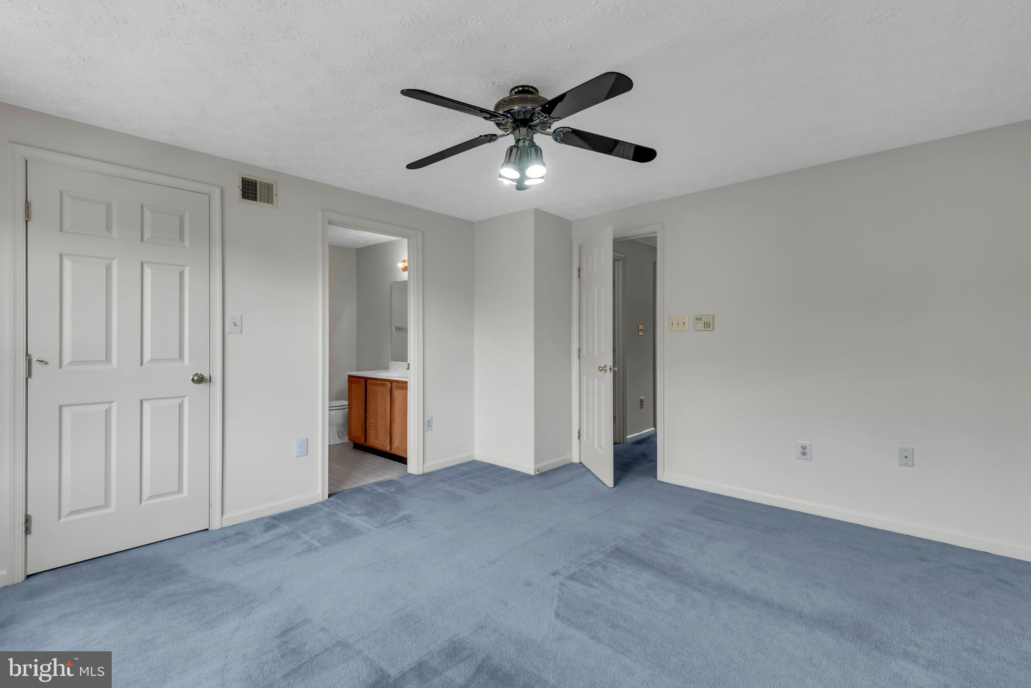 2407 Warm Spring Way Odenton, MD 21113 - Photo 18 of 45 a view of an empty room with a ceiling fan