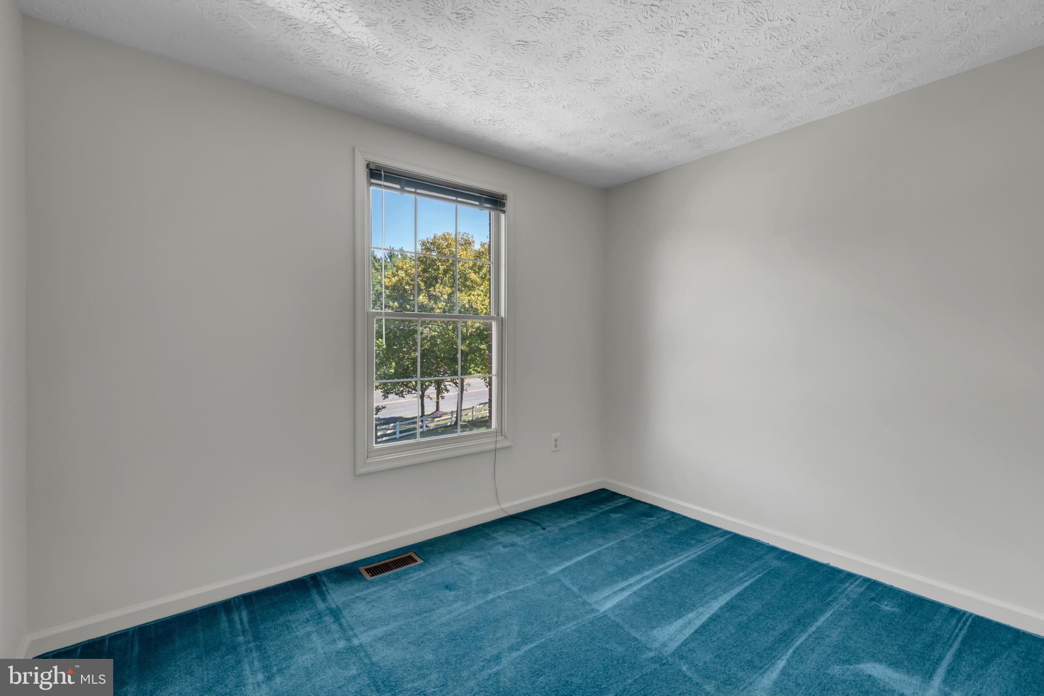 2407 Warm Spring Way Odenton, MD 21113 - Photo 22 of 45 an empty room with wooden floor and windows